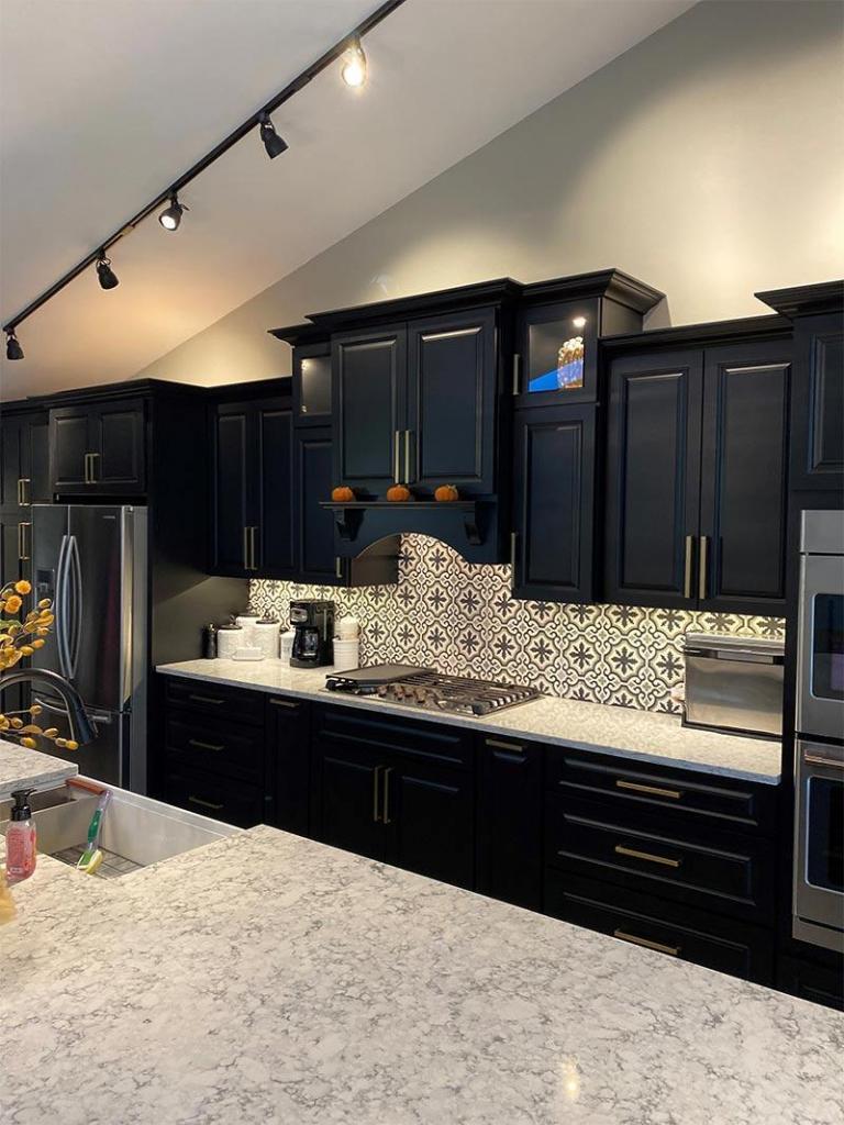 black cabinets with custom backsplash