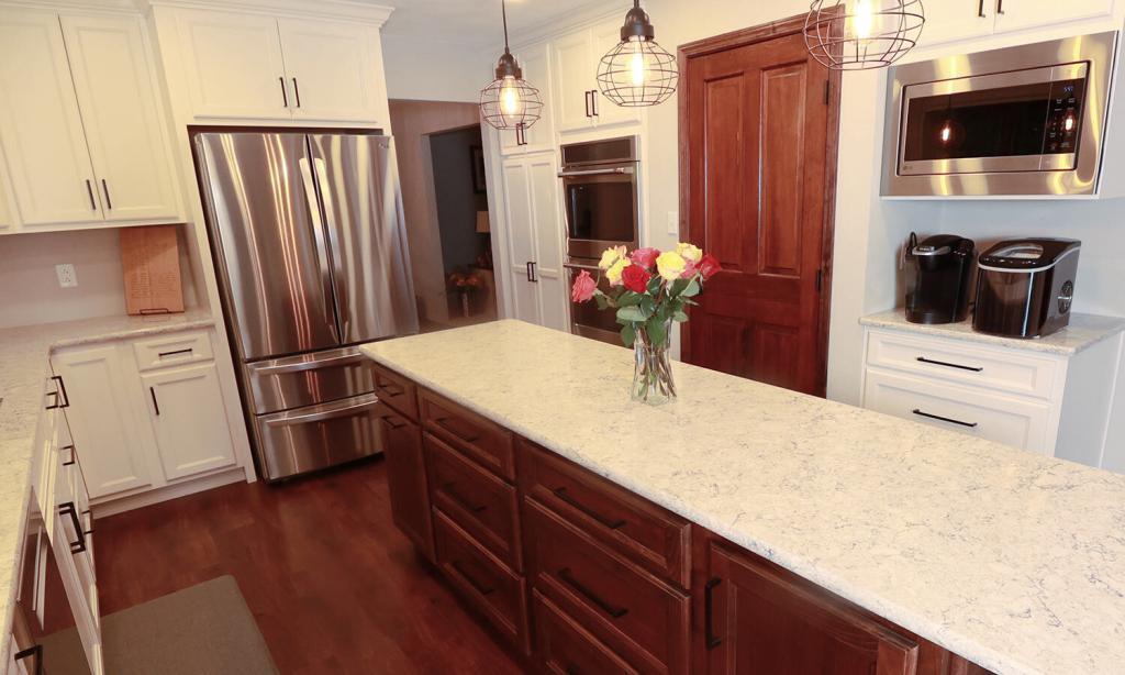 beautiful kitchen with white cabinets and quartz counters