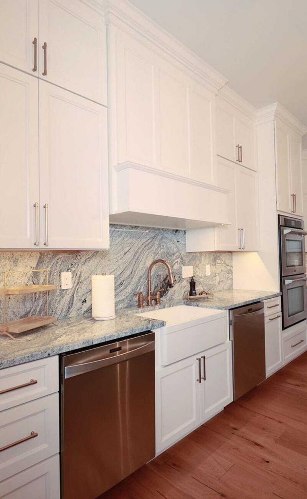 luxury kitchen with white cabinets and quartz counter