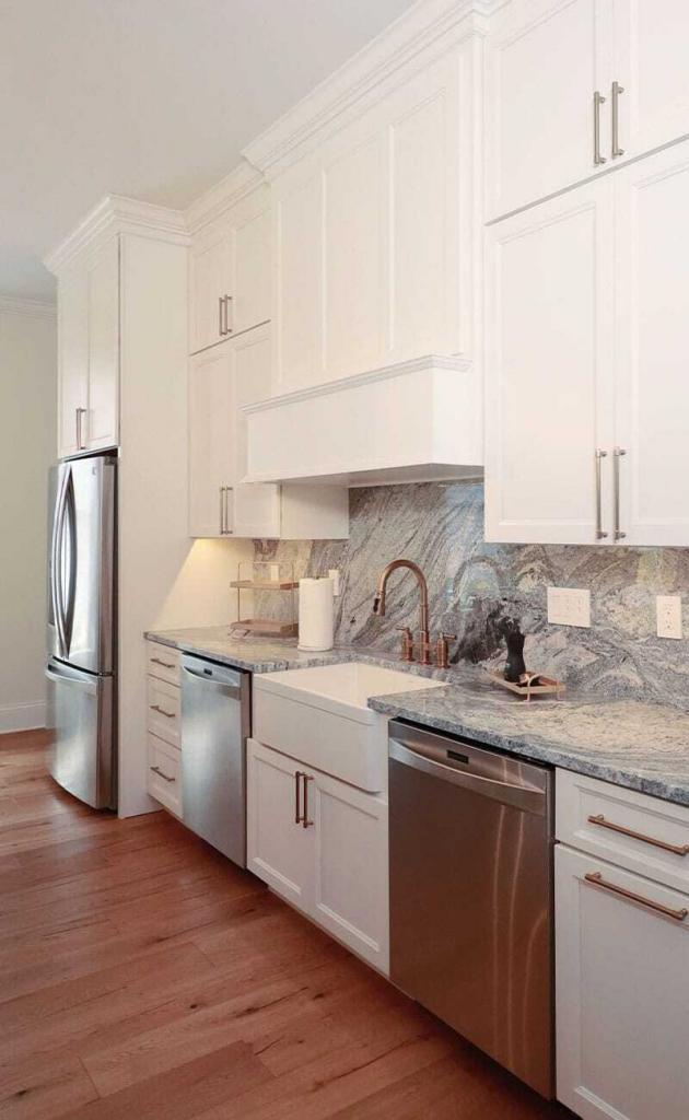 luxury kitchen with white cabinets and quartz counter