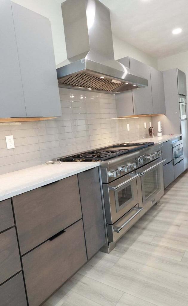 modern kitchen with white tile and gray cabinets