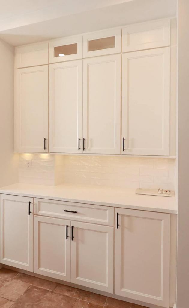 white cabinets with white tile backsplash