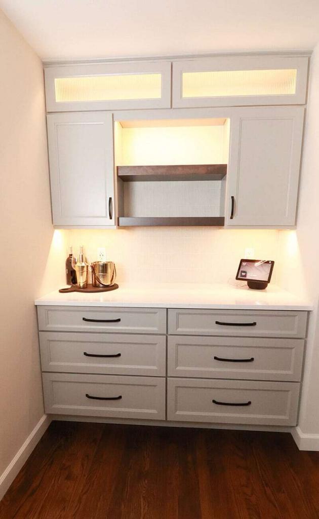 white cabinets with backlighting built-in desk
