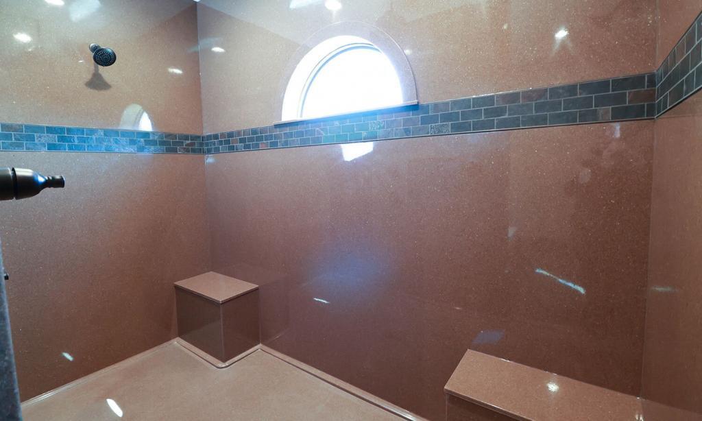 brown quartz built-in large shower area with arch window