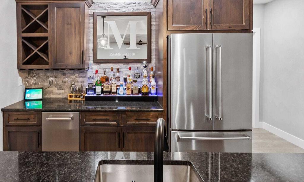 basement bar with stainless steel appliances