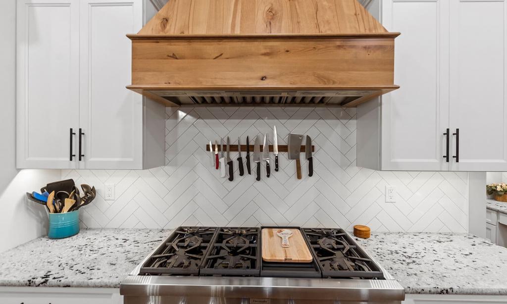 modern white kitchen with wood range hood