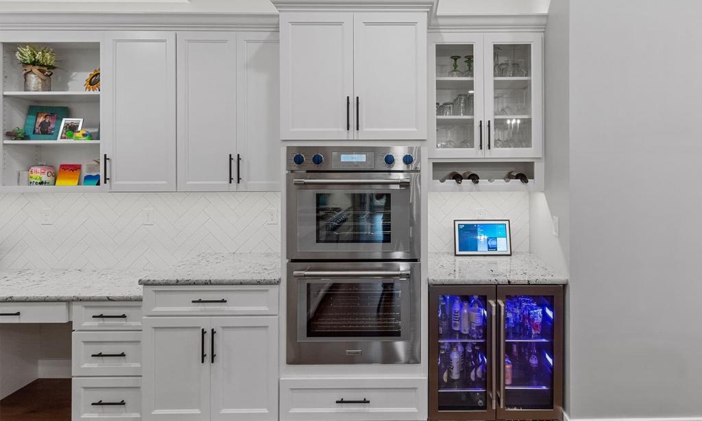 modern white cabinets with a under counter beverage refrigerator